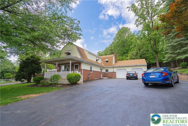 3082 Pricetown Rd, Pa, PA 19560 - view of front of home with a gambrel roof, covered porch, brick siding, a garage, and a chimney