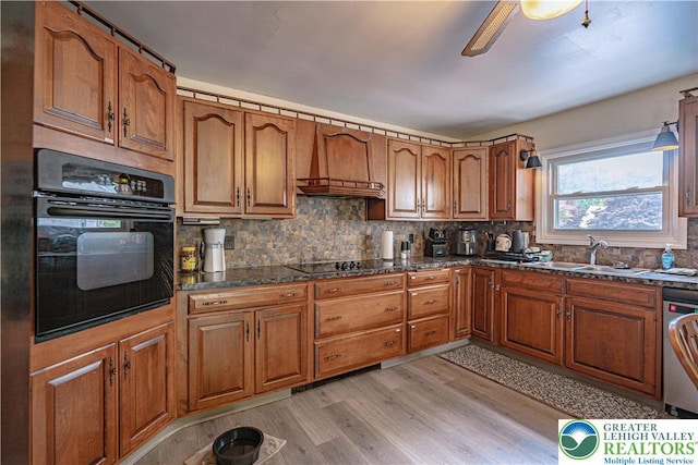 3082 Pricetown Rd, Pa, PA 19560 - kitchen with black appliances, light wood-style floors, brown cabinets, and a sink