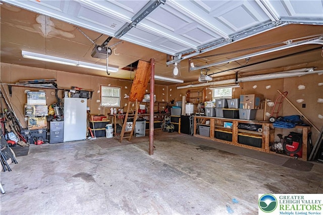 3082 Pricetown Rd, Pa, PA 19560 - garage featuring a workshop area, freestanding refrigerator, and a garage door opener