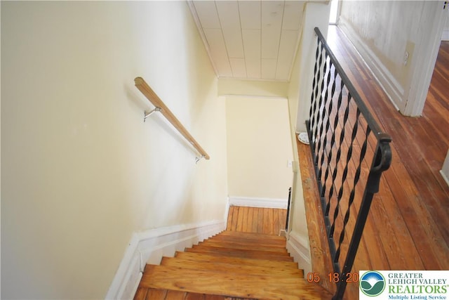 stairway featuring hardwood / wood-style floors