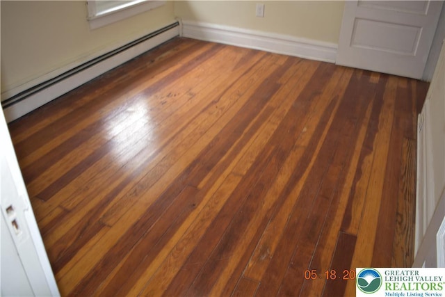 detailed view of baseboard heating and wood finished floors