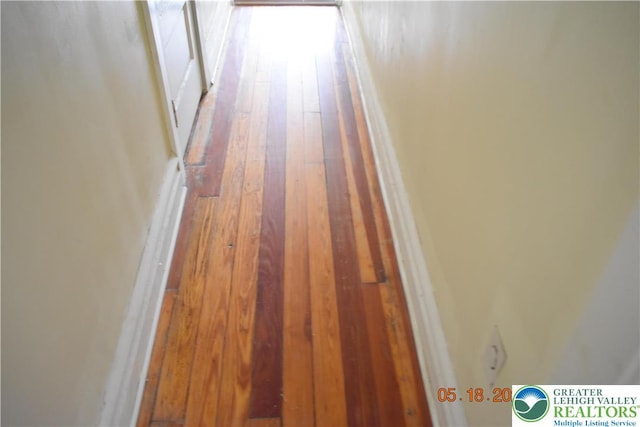 hall with hardwood / wood-style flooring