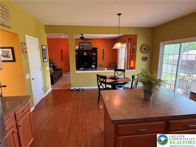 1557 Bridgeton Rd, Upper Macungie Twp, PA 18031 - kitchen with ceiling fan, dark wood-type flooring, baseboards, decorative light fixtures, and dark countertops
