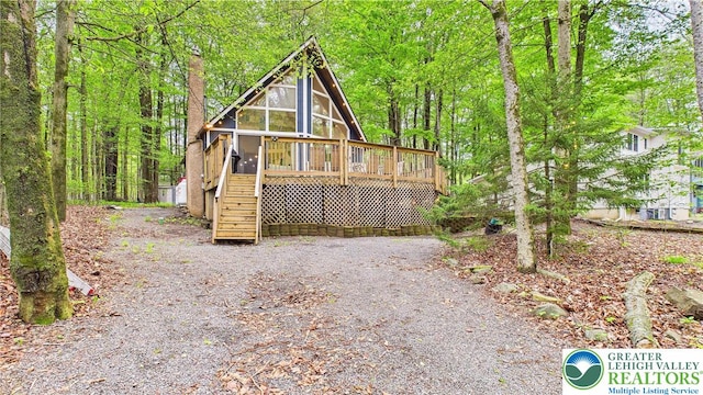 112 Moshannon Dr, Coolbaugh Twp, PA 18347 - view of front of house featuring stairs, a wooden deck, and a sunroom