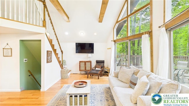 112 Moshannon Dr, Coolbaugh Twp, PA 18347 - living area featuring high vaulted ceiling, beamed ceiling, wood finished floors, and baseboards