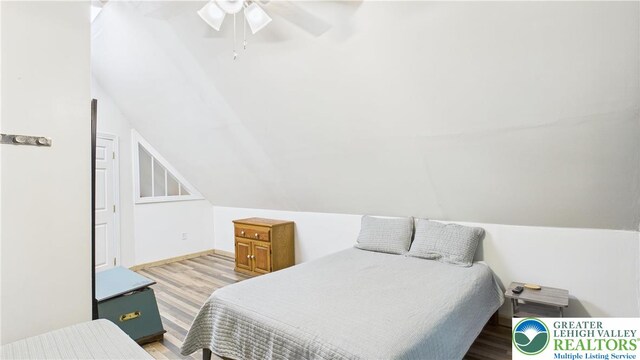 112 Moshannon Dr, Coolbaugh Twp, PA 18347 - bedroom with wood finished floors, ceiling fan, baseboards, and lofted ceiling