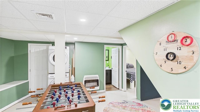 112 Moshannon Dr, Coolbaugh Twp, PA 18347 - rec room featuring stacked washer and clothes dryer, a paneled ceiling, and heating unit