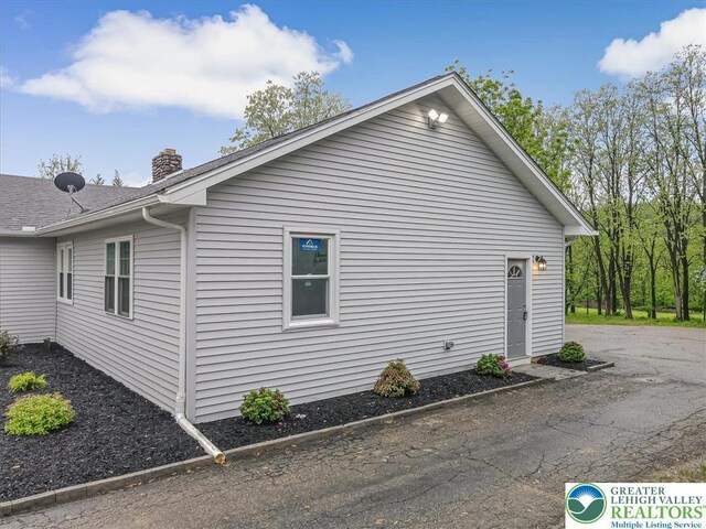5653 Sullivan Trl, Plainfield Twp, PA 18064 - view of property exterior with a chimney