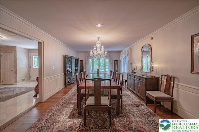 1845 Lehigh Pkwy N, Allentown City, PA 18103 - dining space with a chandelier, healthy amount of natural light, a decorative wall, ornamental molding, and wood finished floors