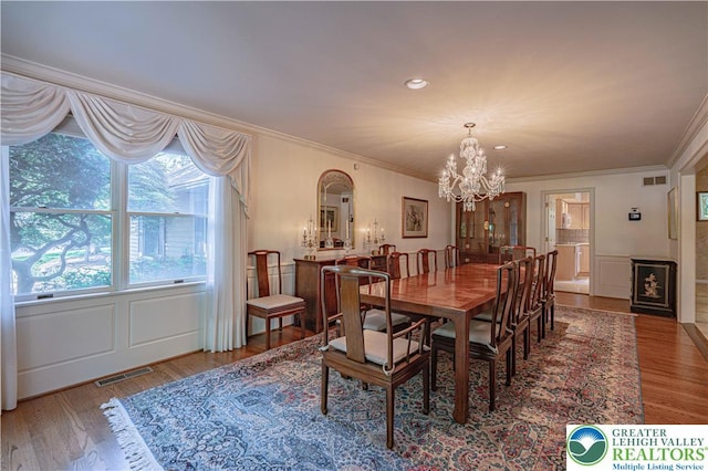 1845 Lehigh Pkwy N, Allentown City, PA 18103 - dining room with a chandelier, crown molding, wood finished floors, a decorative wall, and wainscoting
