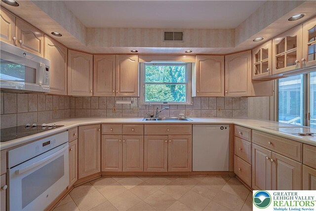 1845 Lehigh Pkwy N, Allentown City, PA 18103 - kitchen featuring white appliances, a sink, light countertops, light brown cabinets, and recessed lighting