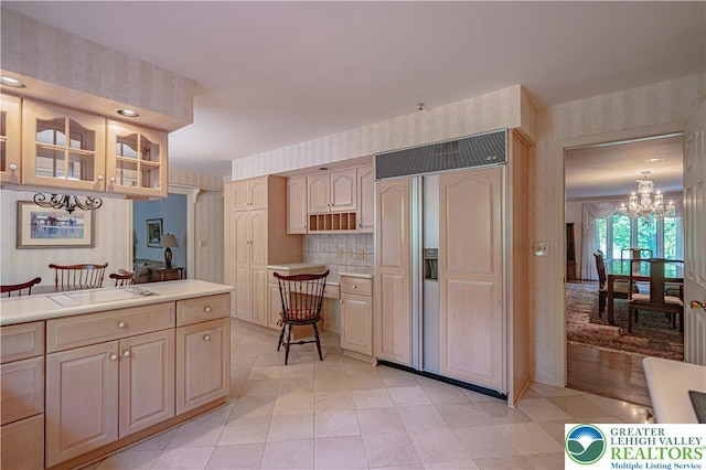 1845 Lehigh Pkwy N, Allentown City, PA 18103 - kitchen featuring paneled built in refrigerator, wallpapered walls, a chandelier, glass insert cabinets, and light countertops