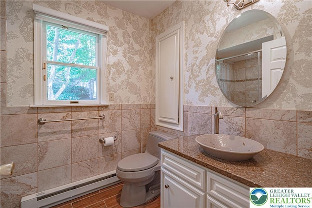 1845 Lehigh Pkwy N, Allentown City, PA 18103 - bathroom featuring a baseboard heating unit, tile walls, wood finished floors, toilet, and wainscoting
