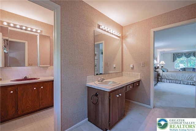1845 Lehigh Pkwy N, Allentown City, PA 18103 - ensuite bathroom featuring two vanities, tasteful backsplash, and baseboards