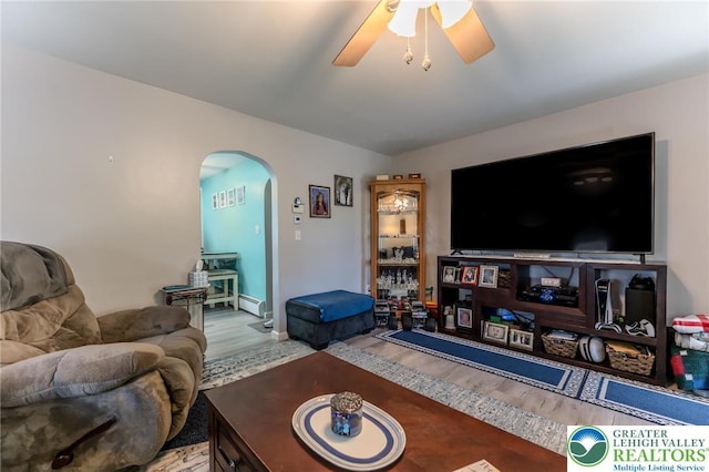46 Jefferson St, Weatherly Borough, PA 18255 - living room featuring arched walkways, wood finished floors, a ceiling fan, a baseboard radiator, and baseboards