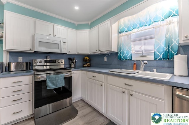46 Jefferson St, Weatherly Borough, PA 18255 - kitchen featuring appliances with stainless steel finishes, a sink, ornamental molding, white cabinetry, and light wood-style floors