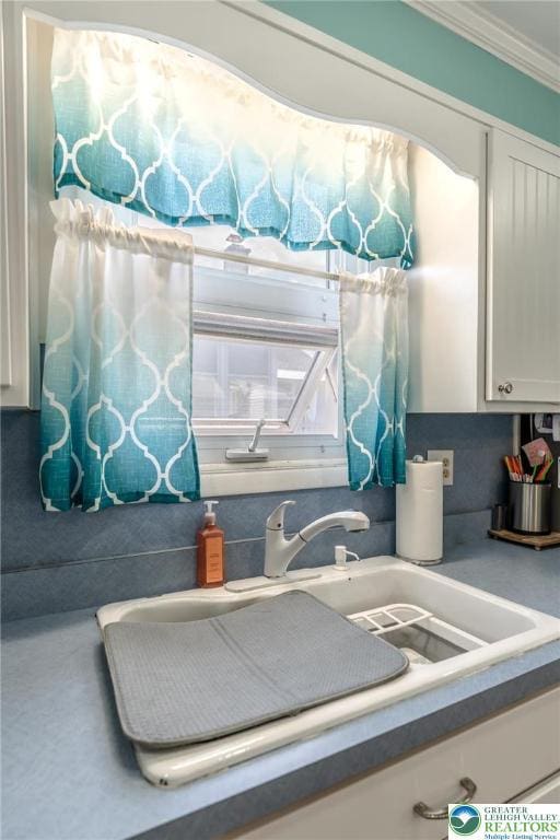 46 Jefferson St, Weatherly Borough, PA 18255 - kitchen view of a sink, white cabinetry, and crown molding