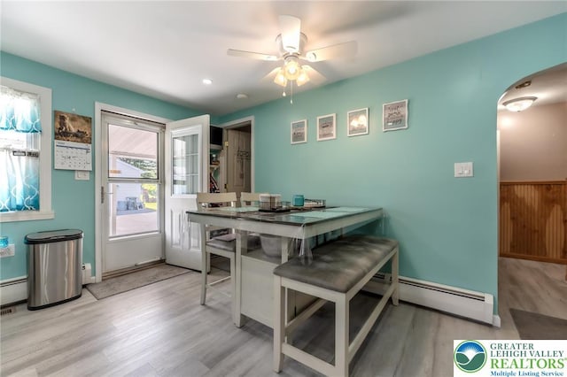 46 Jefferson St, Weatherly Borough, PA 18255 - dining space with arched walkways, a baseboard heating unit, wood finished floors, and a ceiling fan