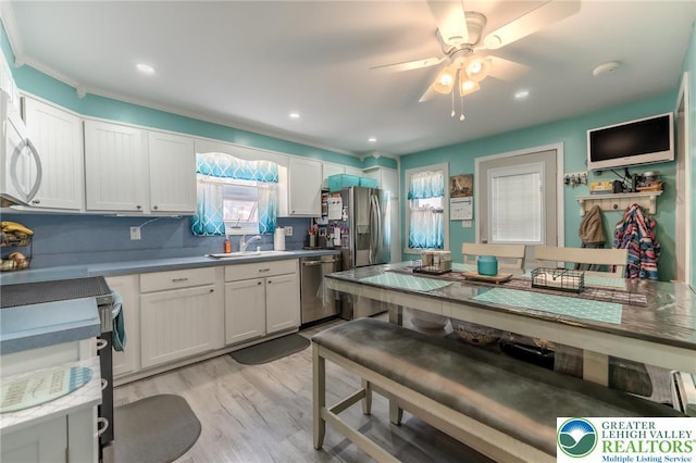 46 Jefferson St, Weatherly Borough, PA 18255 - kitchen featuring stainless steel appliances, a sink, white cabinetry, light wood finished floors, and ceiling fan