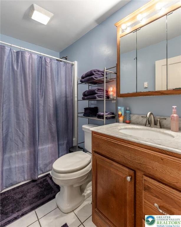 46 Jefferson St, Weatherly Borough, PA 18255 - full bathroom with tile patterned floors, toilet, vanity, and curtained shower
