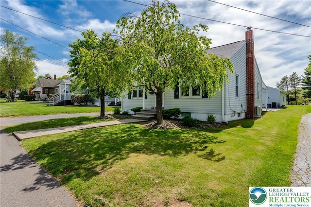 46 Jefferson St, Weatherly Borough, PA 18255 - obstructed view of property featuring a chimney, a front yard, and central air condition unit