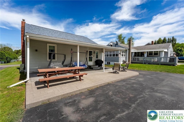 46 Jefferson St, Weatherly Borough, PA 18255 - back of property with a lawn, a chimney, and a patio