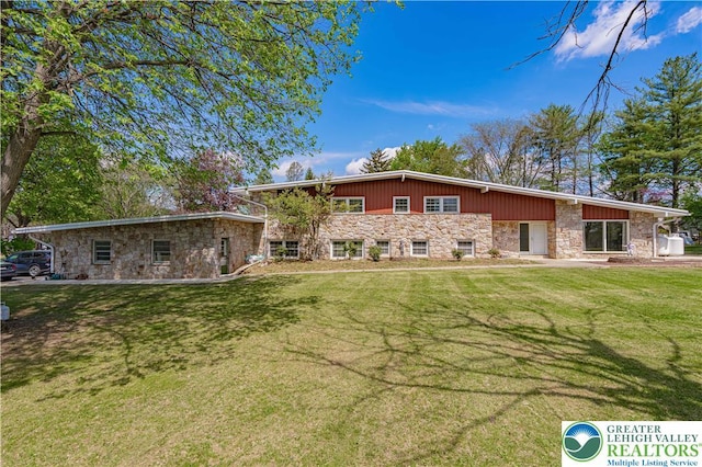 4205 Lehigh St, Whitehall Twp, PA 18052 - rear view of house featuring stone siding and a yard
