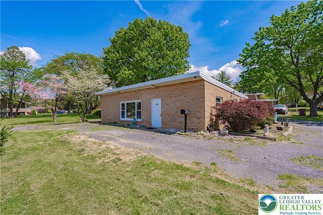 4205 Lehigh St, Whitehall Twp, PA 18052 - view of side of property with brick siding and a yard