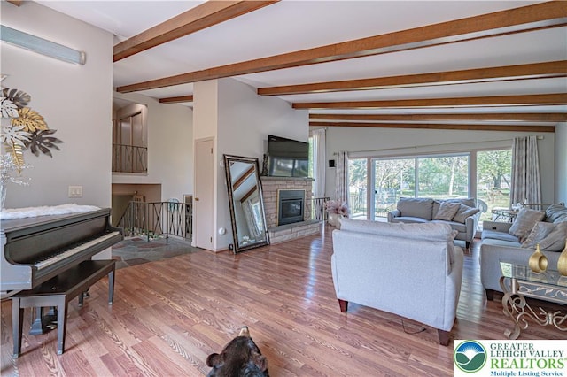 4205 Lehigh St, Whitehall Twp, PA 18052 - living room featuring beam ceiling, wood finished floors, and a stone fireplace