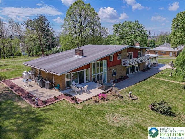 4205 Lehigh St, Whitehall Twp, PA 18052 - rear view of property featuring a chimney, a patio, and a lawn