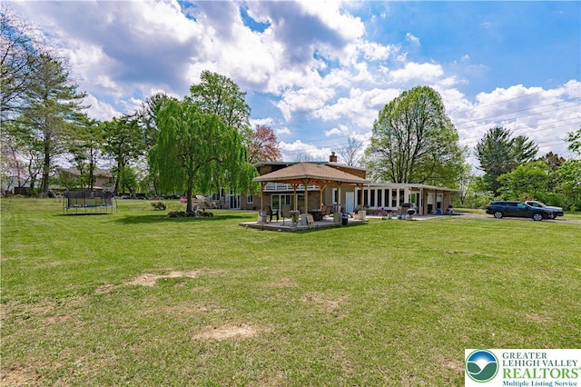 4205 Lehigh St, Whitehall Twp, PA 18052 - view of green lawn with a trampoline, a gazebo, and a patio