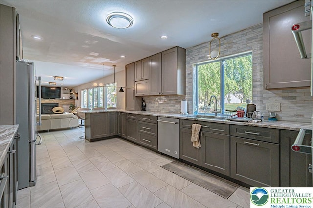 4205 Lehigh St, Whitehall Twp, PA 18052 - kitchen featuring stainless steel appliances, a peninsula, tasteful backsplash, open floor plan, and light stone countertops