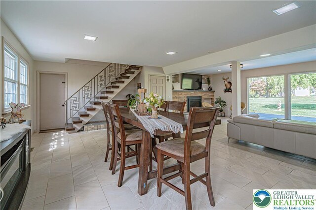 4205 Lehigh St, Whitehall Twp, PA 18052 - dining space with stairs, healthy amount of natural light, a stone fireplace, recessed lighting, and light tile patterned floors