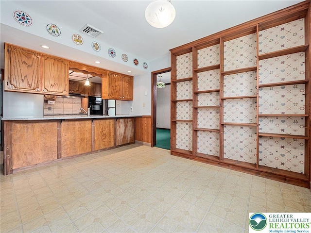1218 Avocet Dr, Upper Macungie Twp, PA 18031 - kitchen featuring light flooring, brown cabinets, tasteful backsplash, light countertops, and a peninsula
