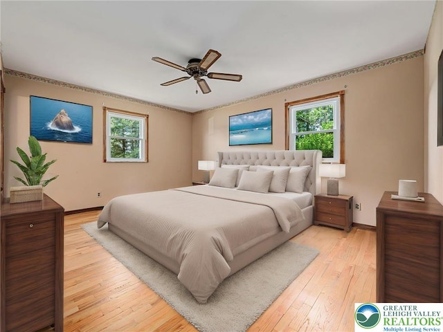 1218 Avocet Dr, Upper Macungie Twp, PA 18031 - bedroom featuring multiple windows, light wood-type flooring, baseboards, and a ceiling fan