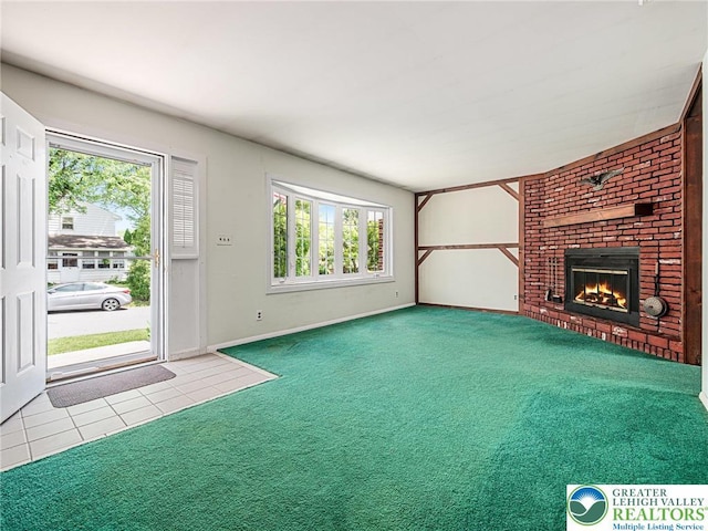 1218 Avocet Dr, Upper Macungie Twp, PA 18031 - unfurnished living room with carpet flooring, a brick fireplace, tile patterned flooring, and baseboards