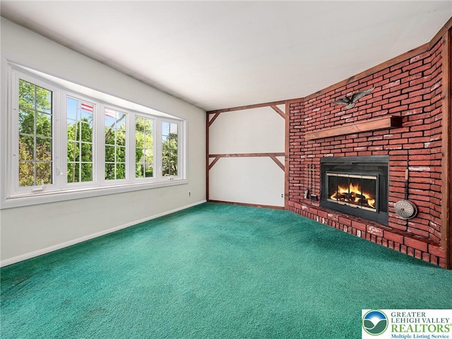 1218 Avocet Dr, Upper Macungie Twp, PA 18031 - unfurnished living room with carpet floors, baseboards, and a brick fireplace
