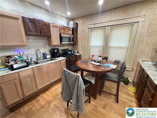 1882 S 2nd St, Allentown City, PA 18103 - kitchen featuring stainless steel microwave, range with gas stovetop, a sink, light wood-style floors, and light countertops