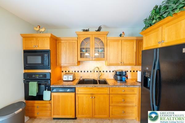 71 N 3rd St, Bangor Borough, PA 18013 - kitchen with black appliances, a sink, glass insert cabinets, backsplash, and light countertops
