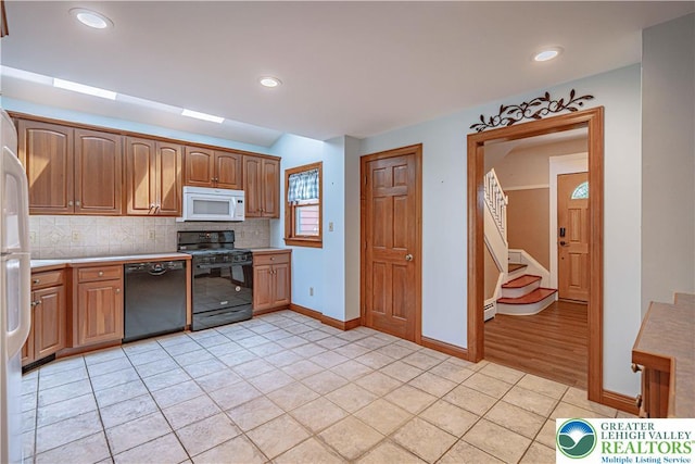 851 N Hoffert St, Fountain Hill Boro, PA 18015 - kitchen featuring black appliances, light tile patterned flooring, backsplash, baseboards, and light countertops