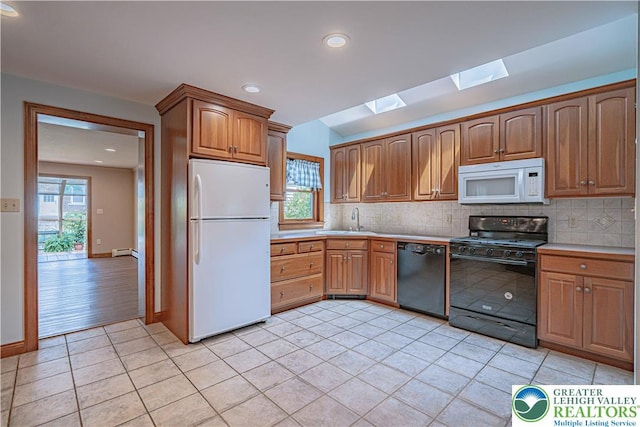 851 N Hoffert St, Fountain Hill Boro, PA 18015 - kitchen with black appliances, a skylight, light tile patterned floors, a sink, and backsplash