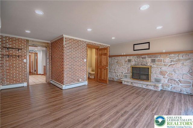 851 N Hoffert St, Fountain Hill Boro, PA 18015 - unfurnished living room featuring a baseboard heating unit, ornamental molding, a fireplace, wood finished floors, and recessed lighting