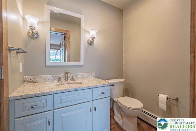 851 N Hoffert St, Fountain Hill Boro, PA 18015 - bathroom with baseboard heating, vanity, toilet, and wood finished floors