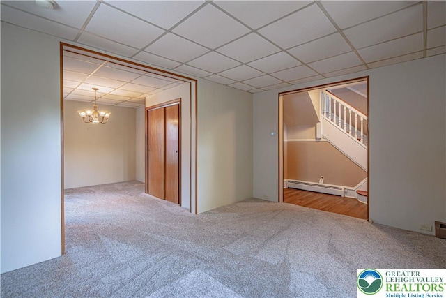 851 N Hoffert St, Fountain Hill Boro, PA 18015 - spare room featuring a drop ceiling, carpet, a baseboard heating unit, a chandelier, and stairway