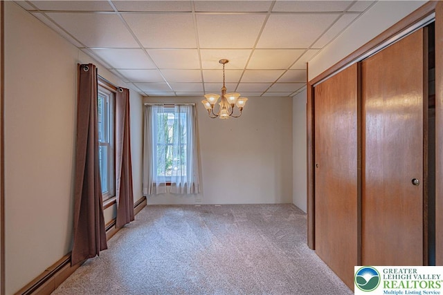 851 N Hoffert St, Fountain Hill Boro, PA 18015 - unfurnished dining area with light colored carpet, a drop ceiling, a chandelier, and a baseboard radiator
