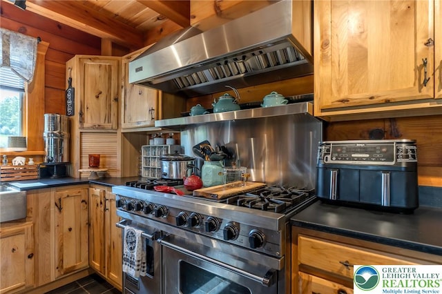 1650 Spruce Hollow Rd, Towamensing Township, PA 18071 - kitchen with wall chimney range hood, range with two ovens, dark countertops, dark tile patterned flooring, and wood ceiling with exposed beams
