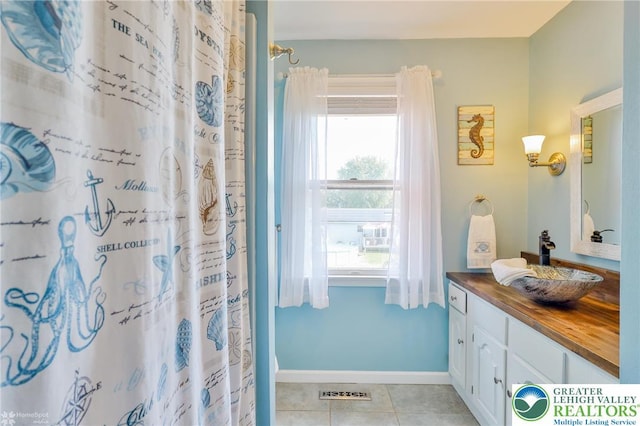 3940 Dewalt St, Bethlehem Twp, PA 18020 - bathroom featuring vanity, tile patterned floors, curtained shower, and baseboards
