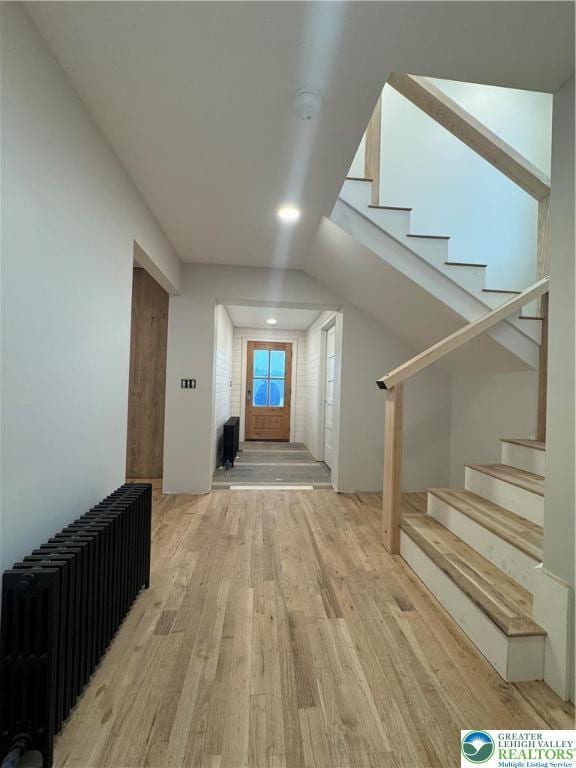 1028 Washington Blvd, Washington Twp, PA 18013 - hallway with light wood finished floors, radiator, and stairway