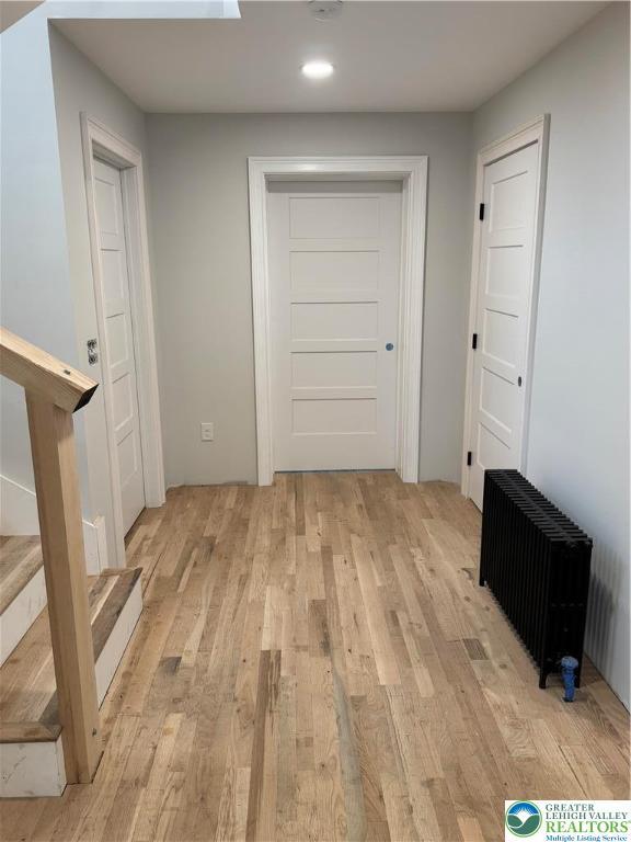 1028 Washington Blvd, Washington Twp, PA 18013 - corridor featuring radiator heating unit, light wood-type flooring, stairs, and recessed lighting