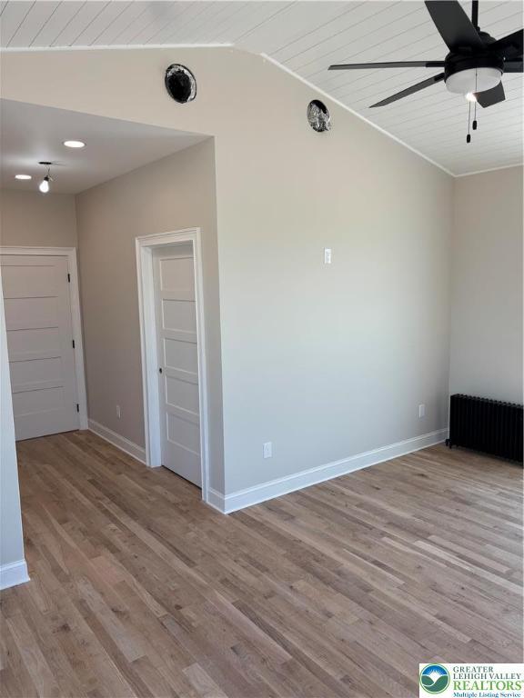 1028 Washington Blvd, Washington Twp, PA 18013 - empty room featuring wood finished floors, ceiling fan, vaulted ceiling, baseboards, and radiator heating unit